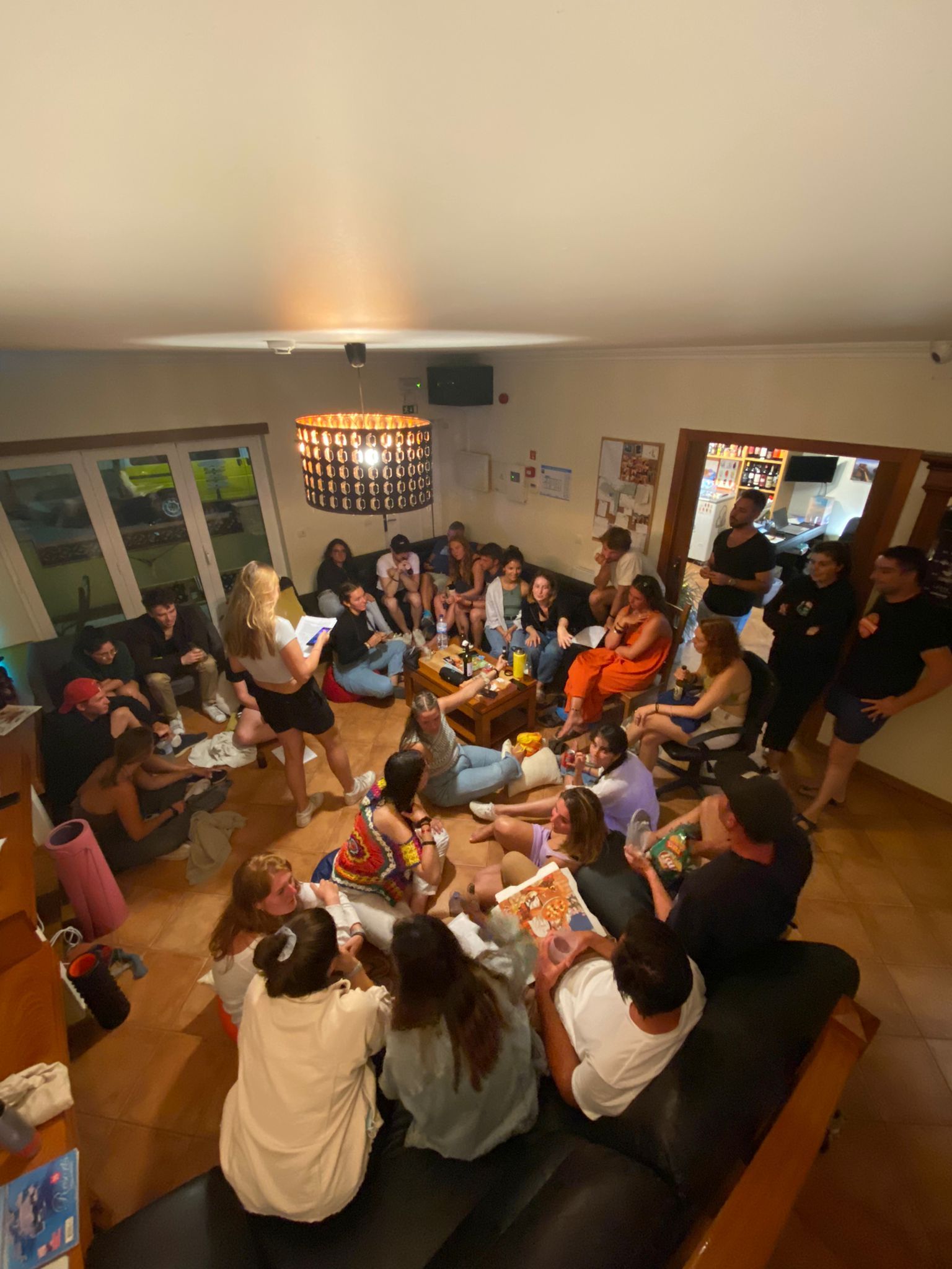 A group of people are sitting on a couch in a living room.