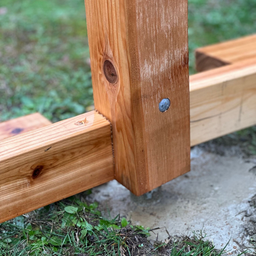 Wooden block with a metal rod inserted into a hole. Glue visible around the rod.