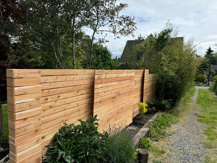 A Backyard with A Table and Chairs and An Umbrella | Issaquah, WA | Neighborly Fencing
