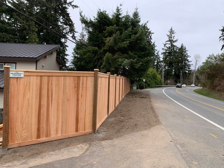 A White Picket Fence Surrounds a Lush Green Field | Issaquah, Wa | Neighborly Fencing