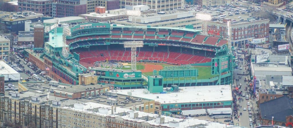 Aerial view of Fenway Park baseball stadium in Boston, Massachusetts, surrounded by city buildings.