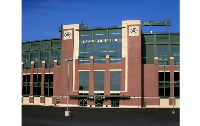 A large brick building with green bay field written on it