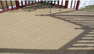 A wooden deck with a table and chairs on it