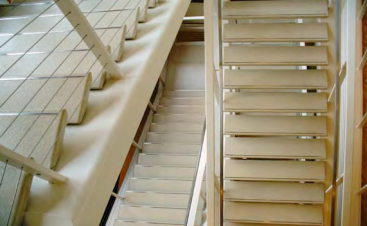 A staircase with white shutters on the side of it