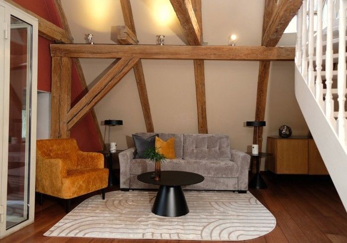 A living room with a couch and two chairs