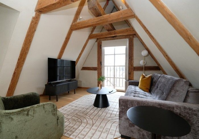 A living room with a couch and a television