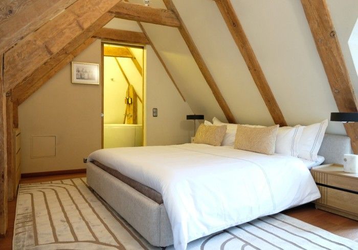 A bedroom with a king size bed in the attic