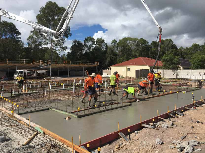 Group of Workers Pouring Concrete With Concrete Equipment — Bampak In Coolum Beach QLD