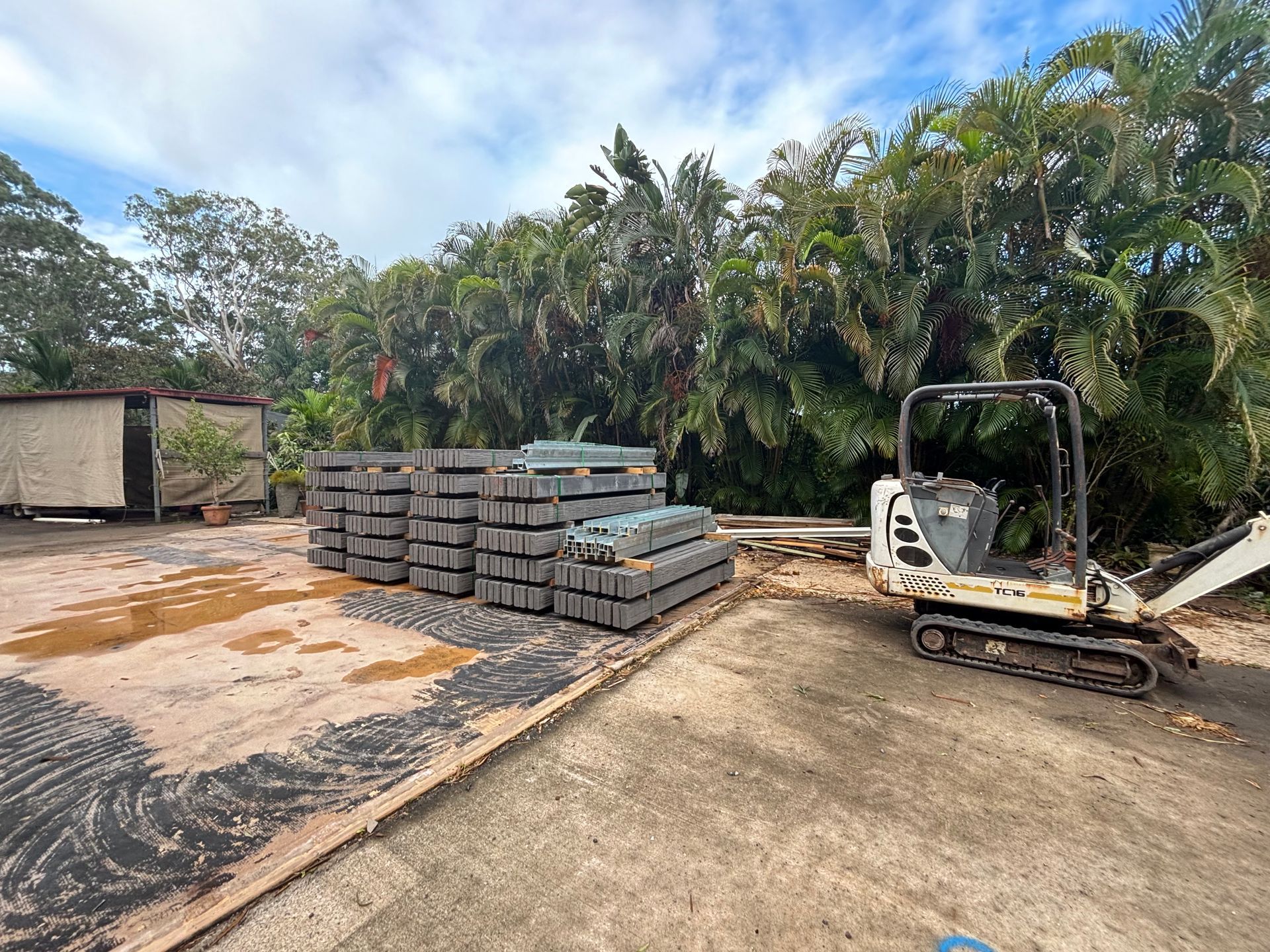 Concrete retaining wall with evenly spaced orange pipes extending from its face, on a grassy hillside — Bampak In Coolum Beach QLD