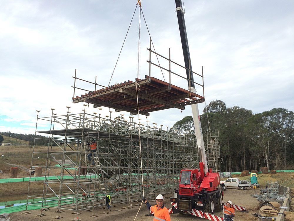 Lifting Up Metal Scaffolding During Concreting Services — Bampak In Coolum Beach QLD