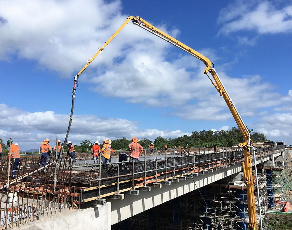 Pouring Concrete Mix onto the Bridge Surface — Bampak In Coolum Beach QLD