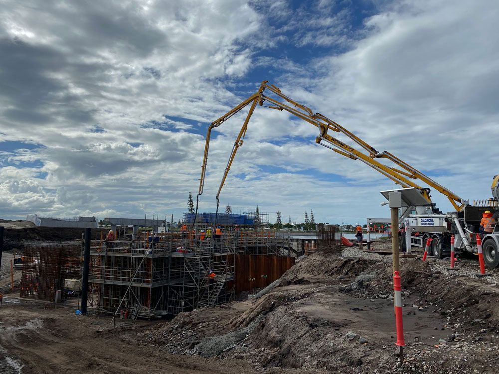 Dual Trucks Pouring Concrete into Bridge Construction Site — Bampak In Coolum Beach QLD