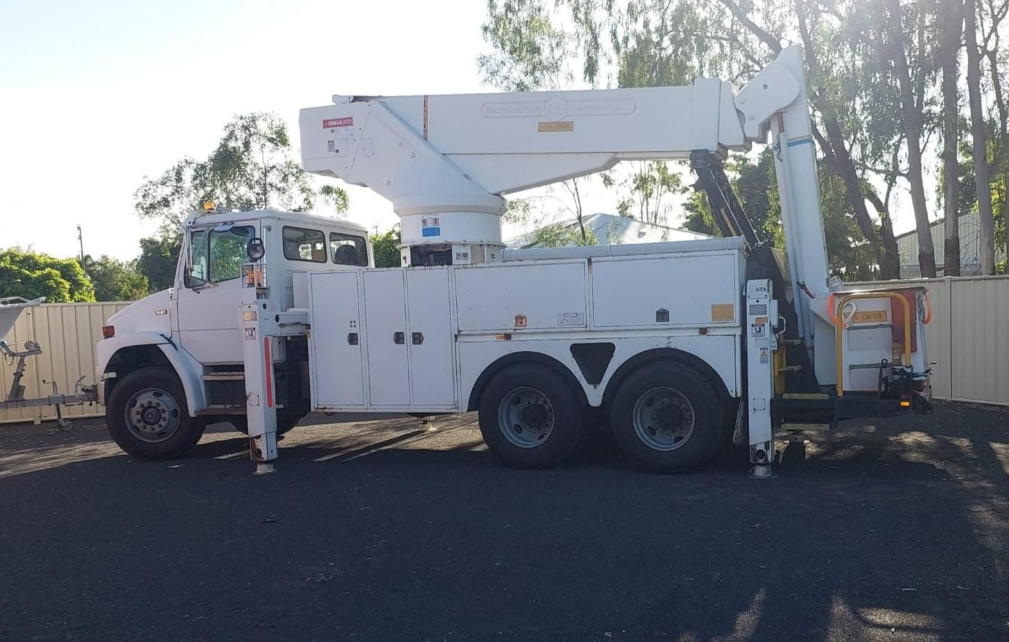 White EWP Bucket Truck On The Road — Emerald Tree Services Pty Ltd in Emerald, QLD