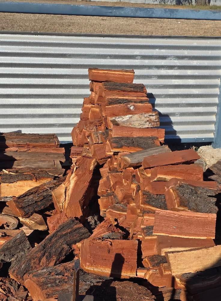 Pile Of Wood Stacked On Top Of Each Other — Emerald Tree Services Pty Ltd in Emerald, QLD