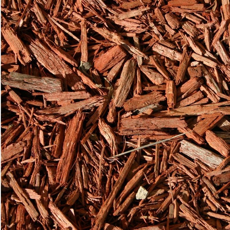 A Pile of brown Mulch is Laying on the Ground — Emerald Tree Services Pty Ltd in Emerald, QLD