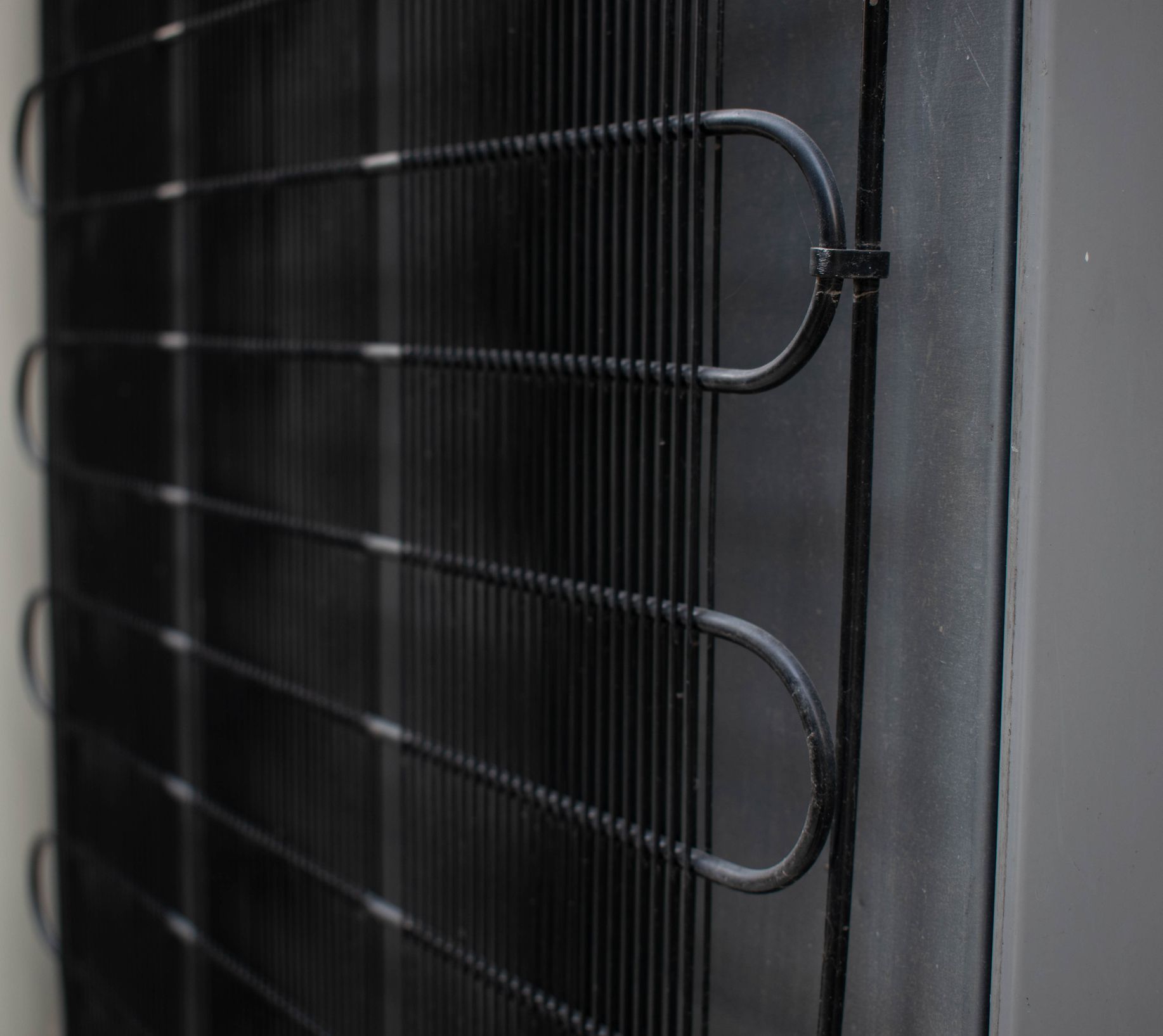 A man is fixing a refrigerator in a kitchen.