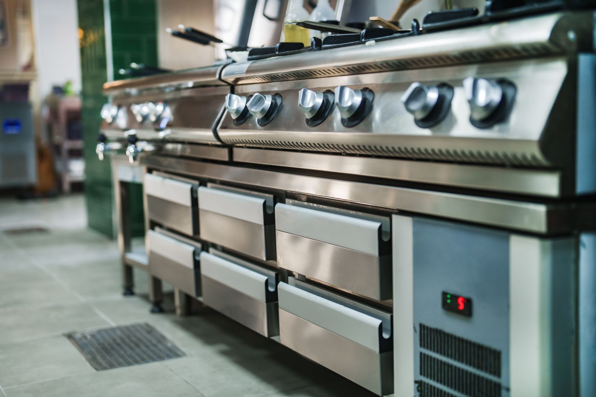 A row of stainless steel appliances in a kitchen.