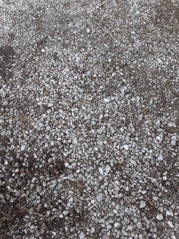 A pile of gravel is sitting on the ground.