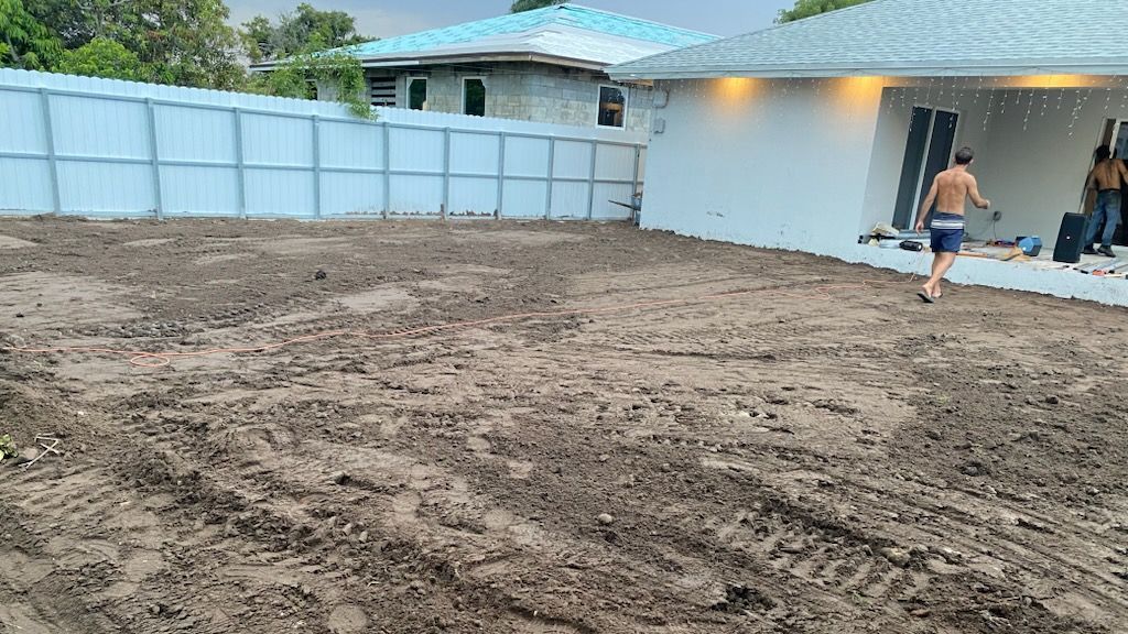 A pile of sand is sitting in front of a house