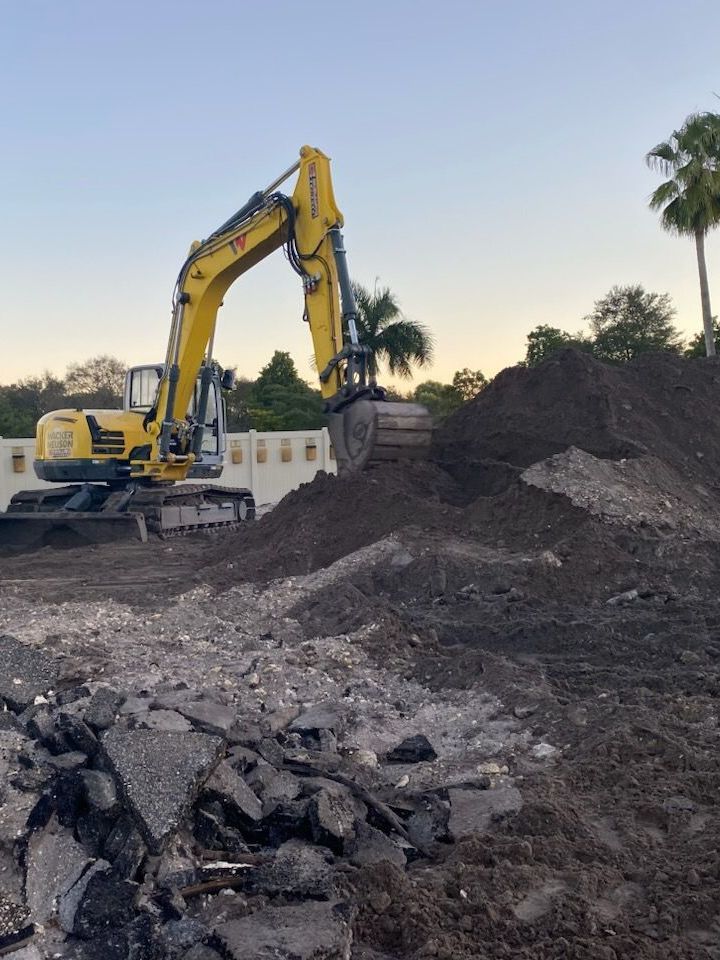 An excavator is loading dirt into a dump truck.