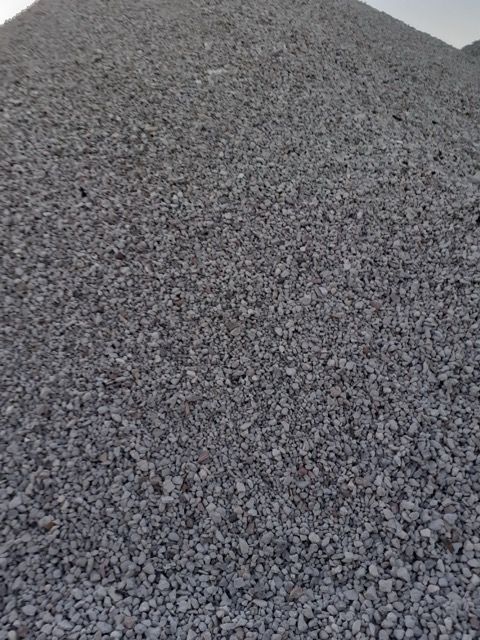 A pile of gravel is sitting on the ground.