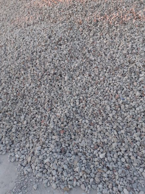 A pile of gravel is sitting on the ground.