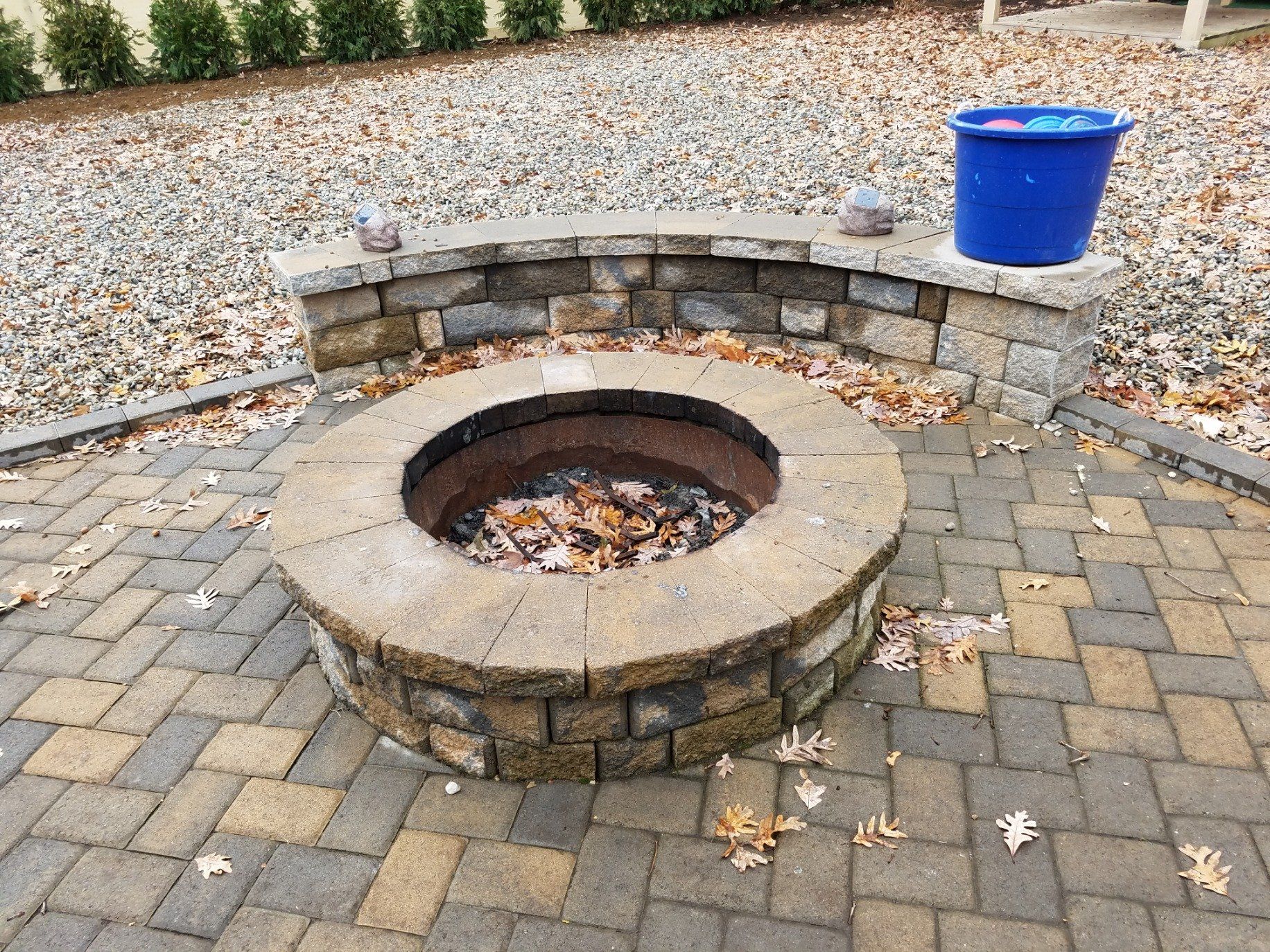 Fire Pit — Bistro Chairs and Table on Stone Paver Bricks Patio in Garden Backyard With Pond in Morris Plains, NJ