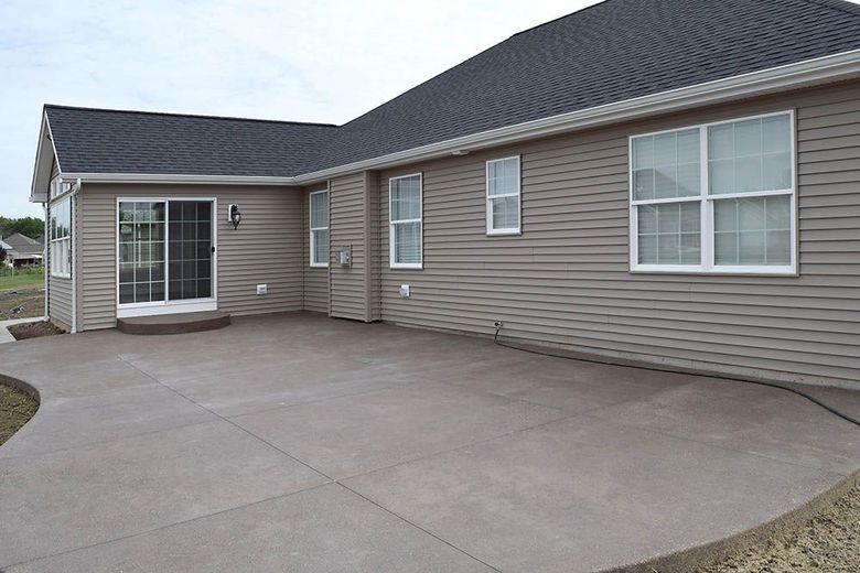 A house with a concrete patio in front of it