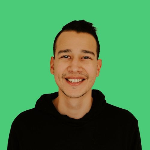 Kevin from KF SEO Media in a black hoodie is smiling in front of a green background