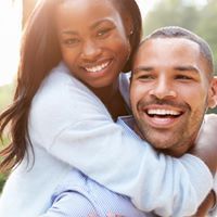 African American woman and man hugging