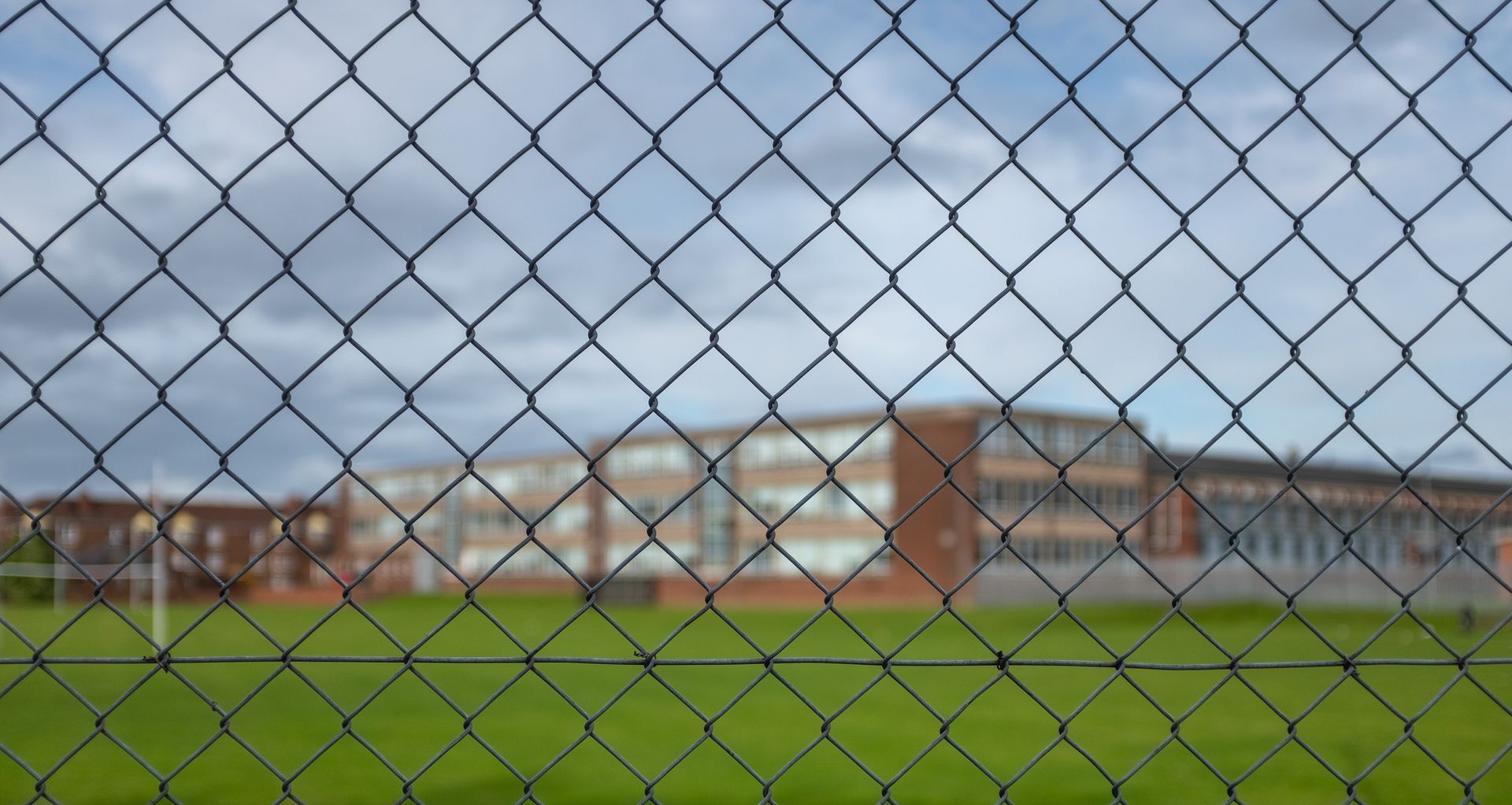 chain link fence securing school grounds for elementary kids