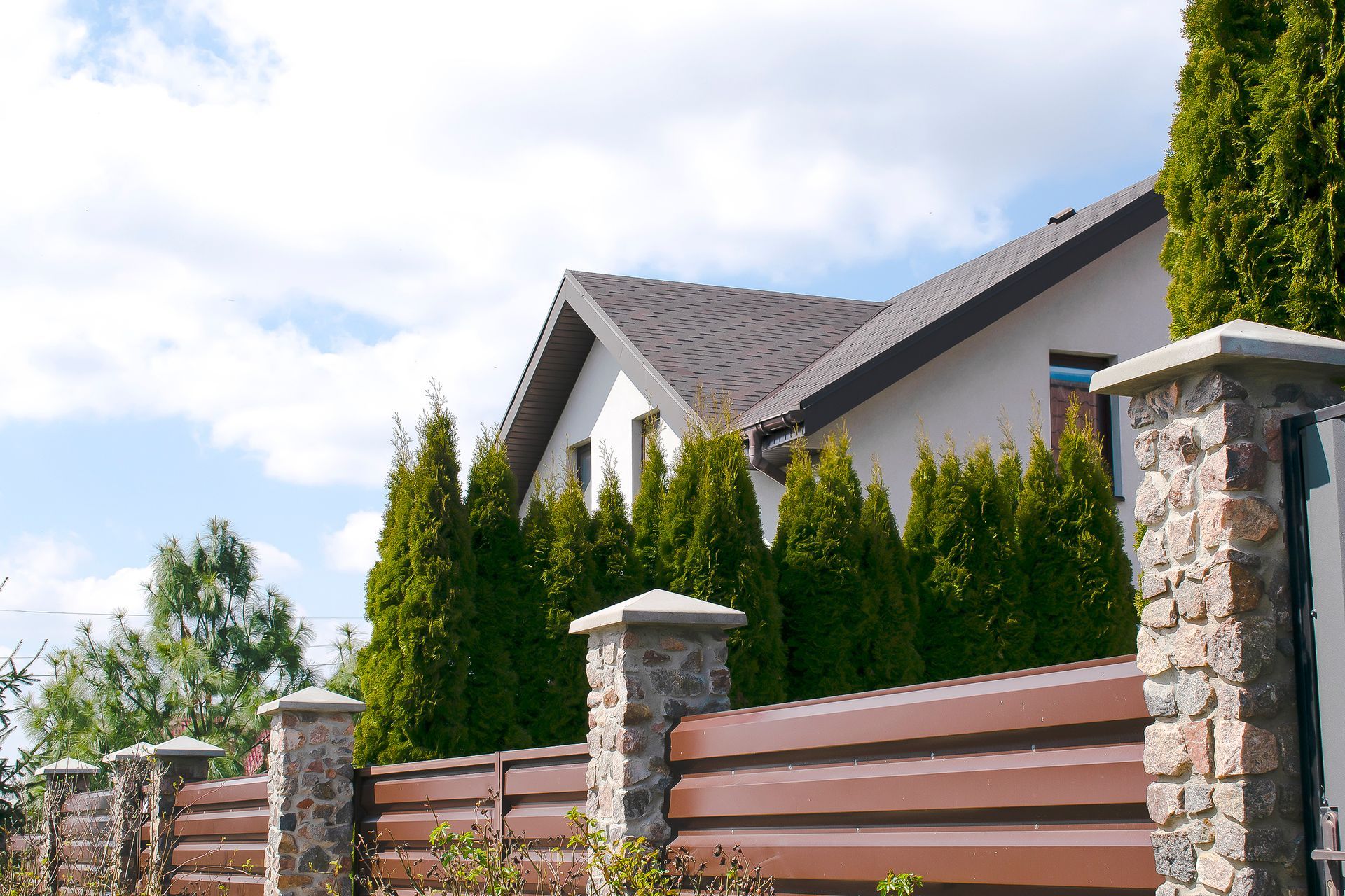 newly installed fence being shown on the side of the home