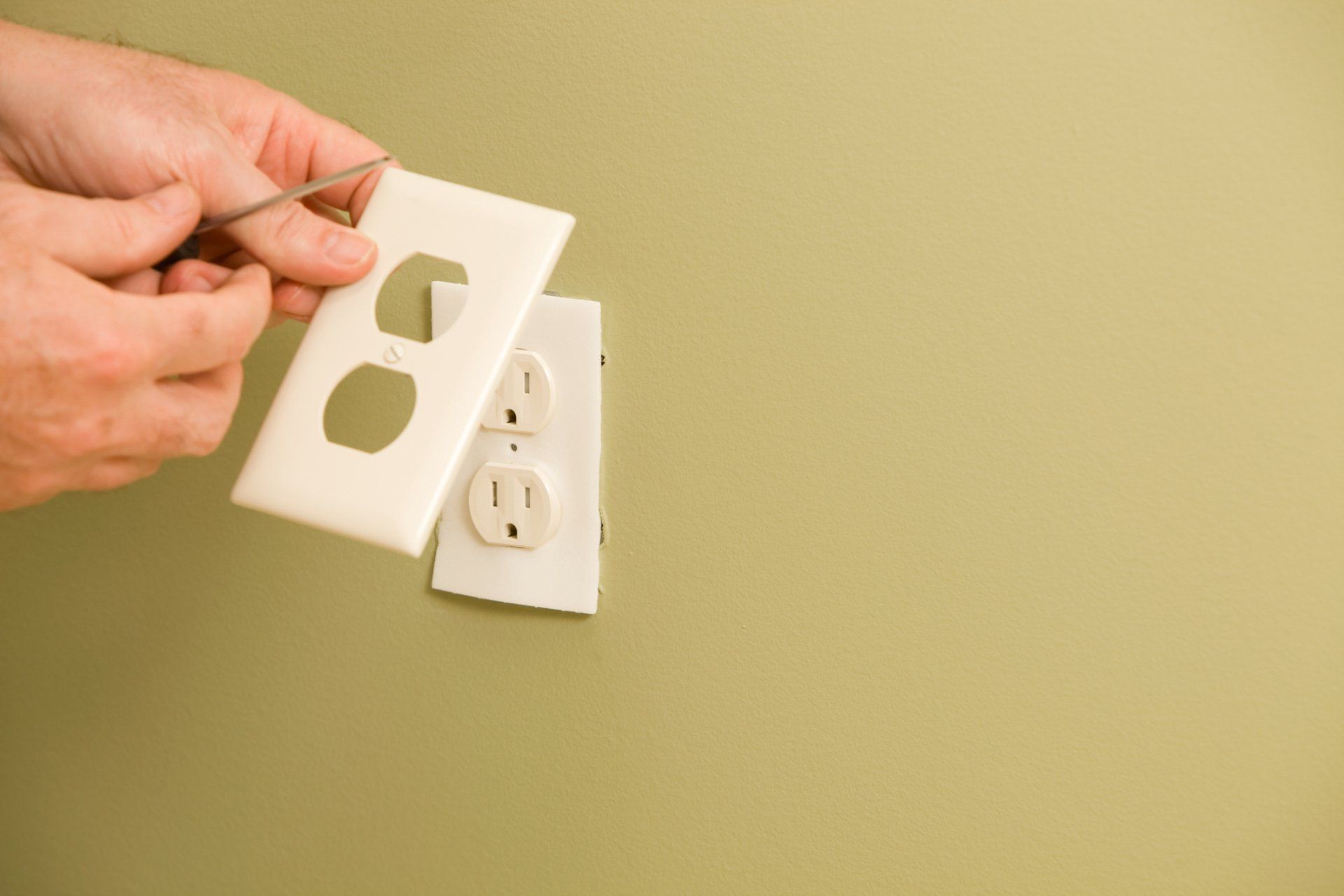 Electric Repair Services — Electrician Repairing the Outlet in Sumner, WA