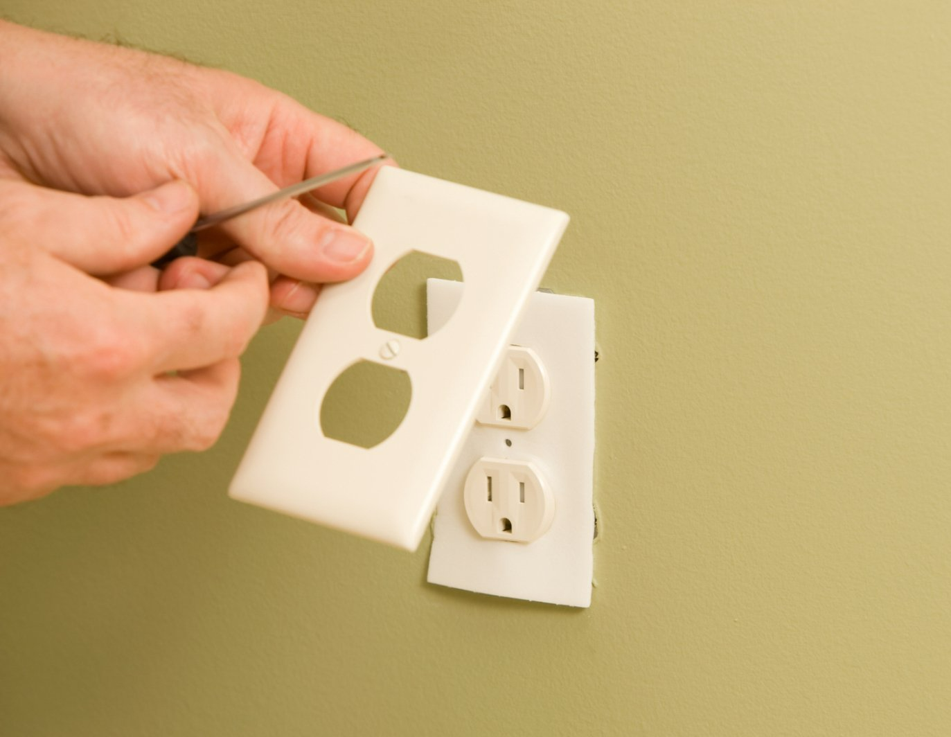 Electric Repair Services — Electrician Repairing the Outlet in Sumner, WA