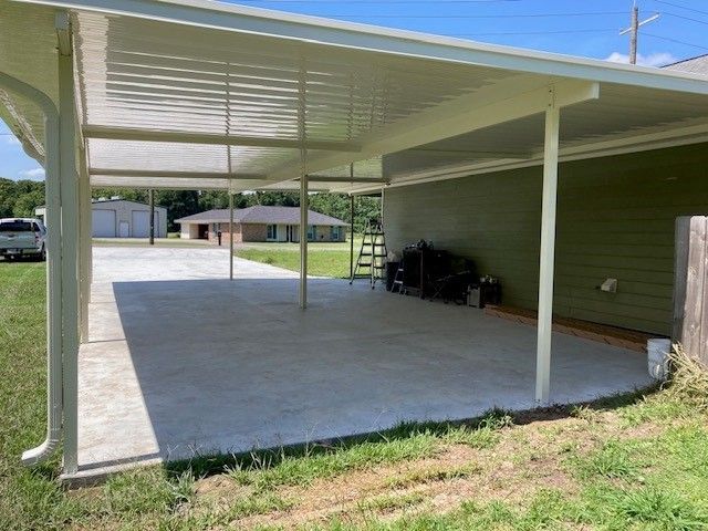 There is a carport with a canopy over it.