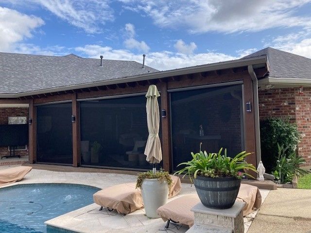 There is a swimming pool in the backyard of a house.
