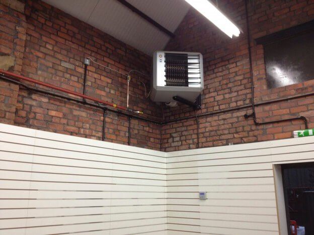 A Garden Centre room with a brick wall and a heater hanging from the ceiling