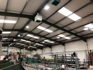 a large warehouse with a lot of lights on the ceiling .