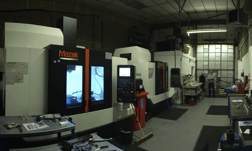 a machine in a factory that says mazak on it