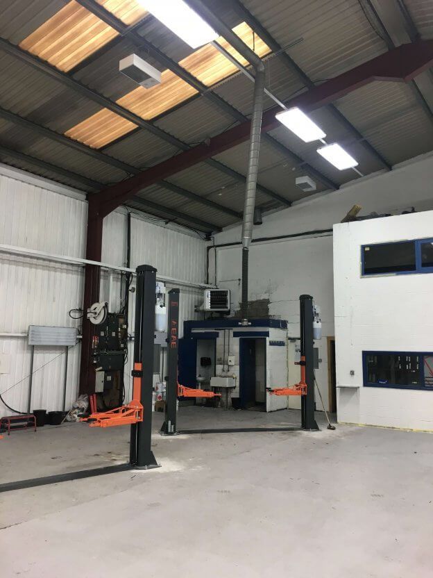 A warehouse with two lifts in the middle of it