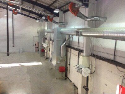 a large room with a lot of pipes hanging from the ceiling .