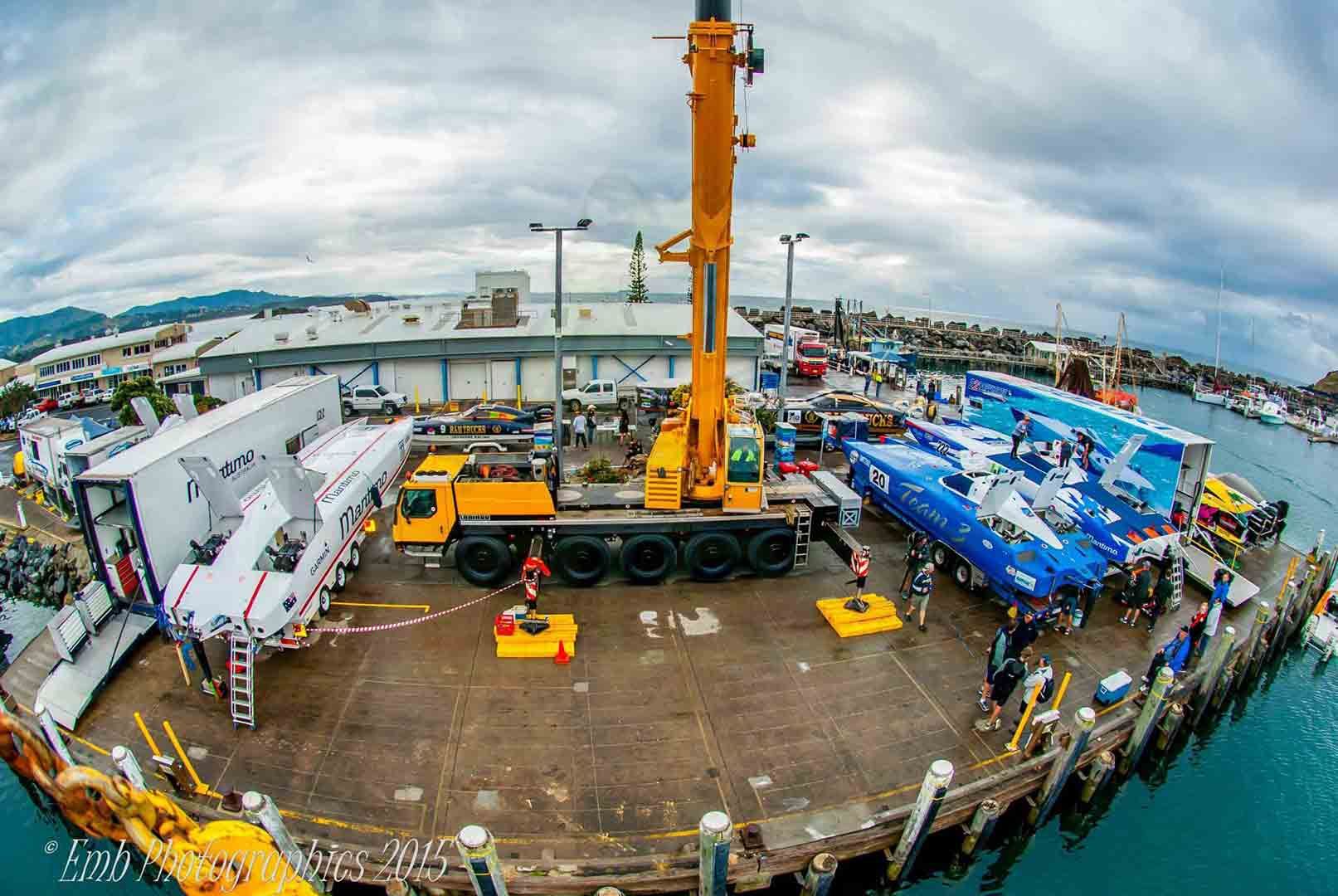 A Large Yellow Crane Is Sitting On Top Of A Dock Next To Boats — North Coast Cranes In Coffs Harbour, NSW