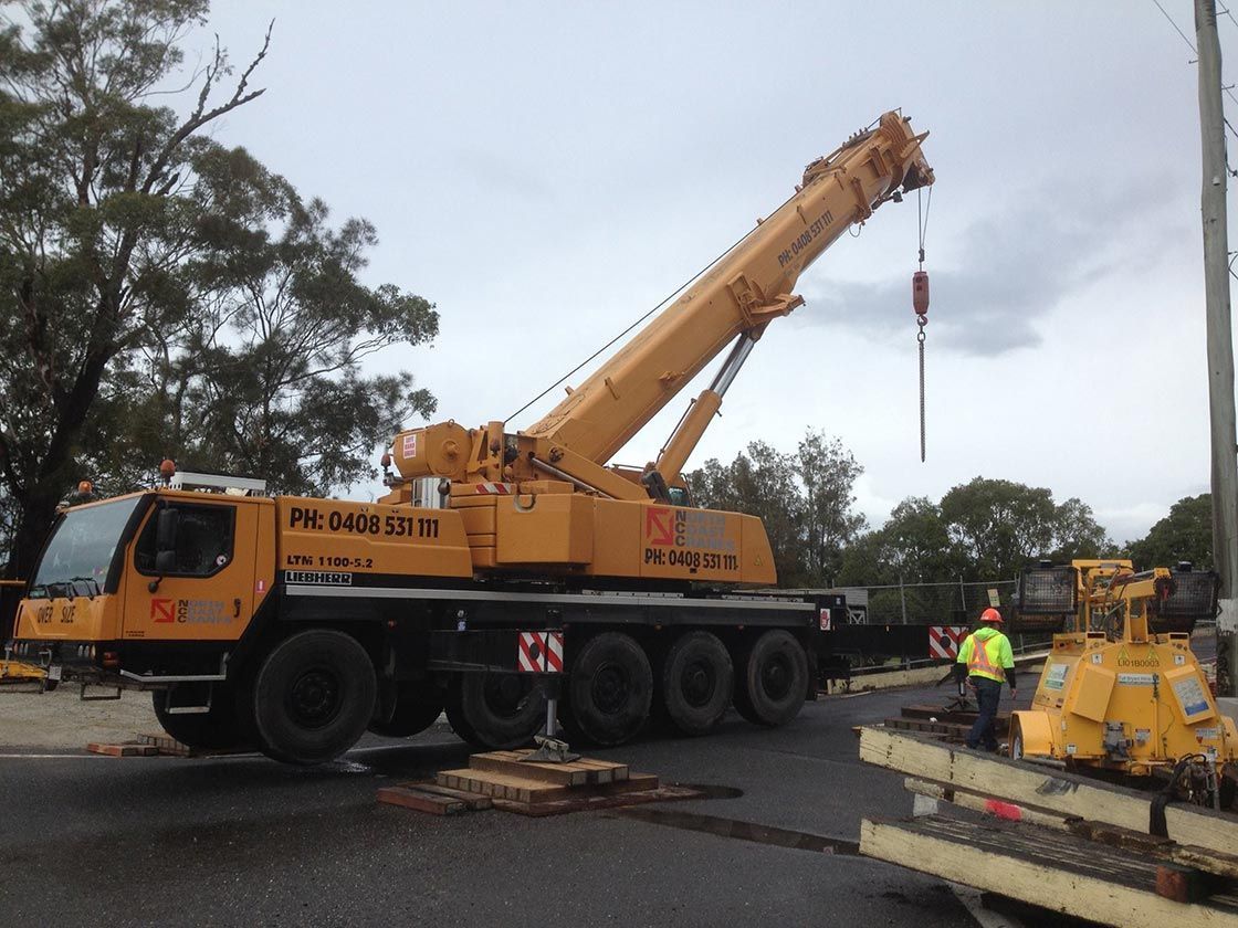 A Large Yellow Crane Is Parked On The Side Of The Road — North Coast Cranes In Armidale, NSW