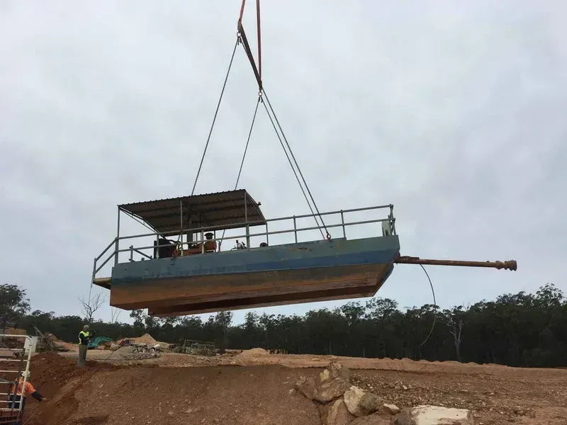 A Boat Is Being Lifted Into the Air by A Crane — North Coast Cranes In Coffs Harbour, NSW