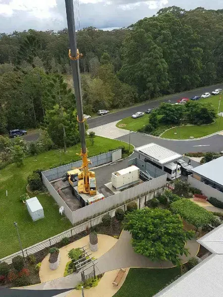 An Aerial View of A Crane Working on A Building — North Coast Cranes In Coffs Harbour, NSW
