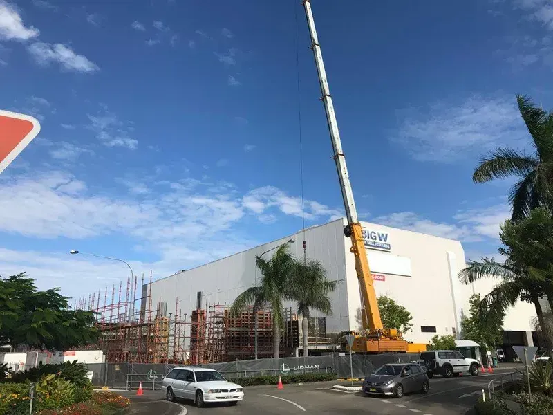 A Large Building Under Construction with A Crane in Front of It — North Coast Cranes In Coffs Harbour, NSW