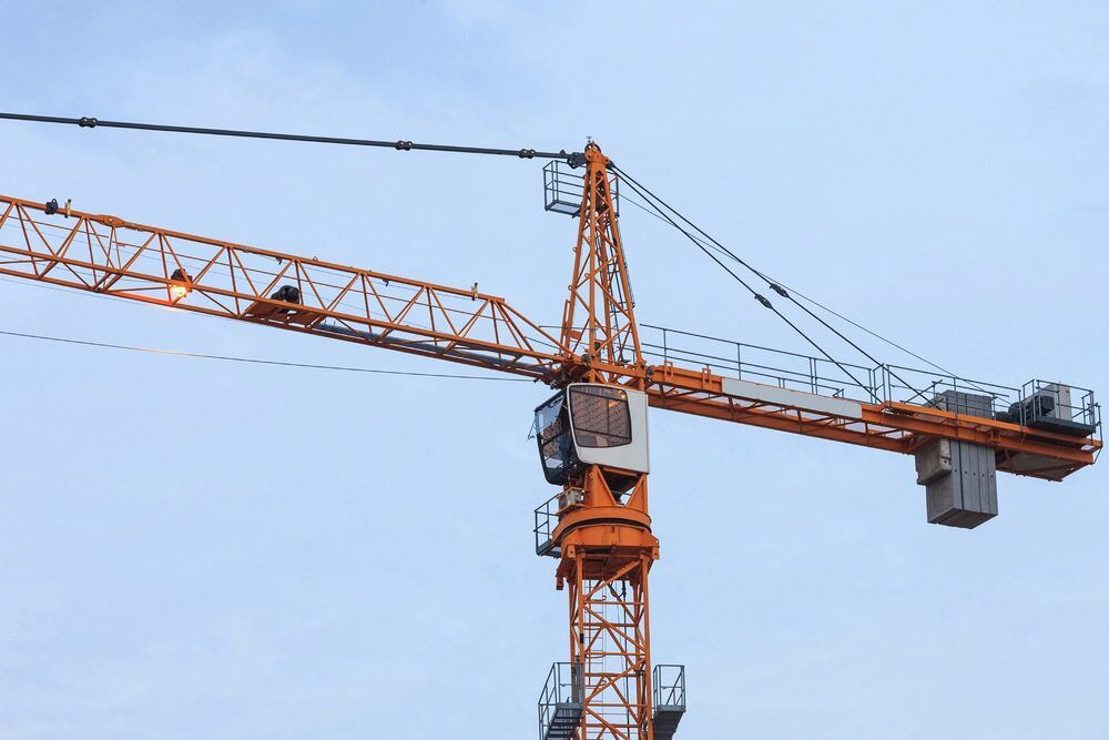 A Large Orange Construction Crane Is Against A Blue Sky — North Coast Cranes In Macksville, NSW