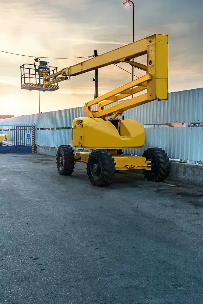 A Yellow Aerial Lift Is Parked in A Parking Lot — North Coast Cranes In Grafton, NSW