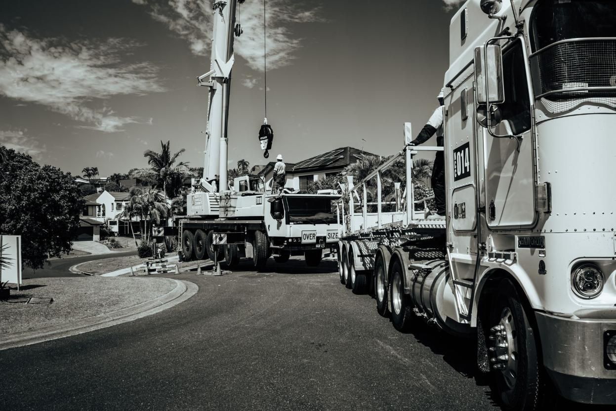 A Black And White Photo Of A Construction Truck Parked On The Side Of The Road — North Coast Cranes In Coffs Harbour, NSW