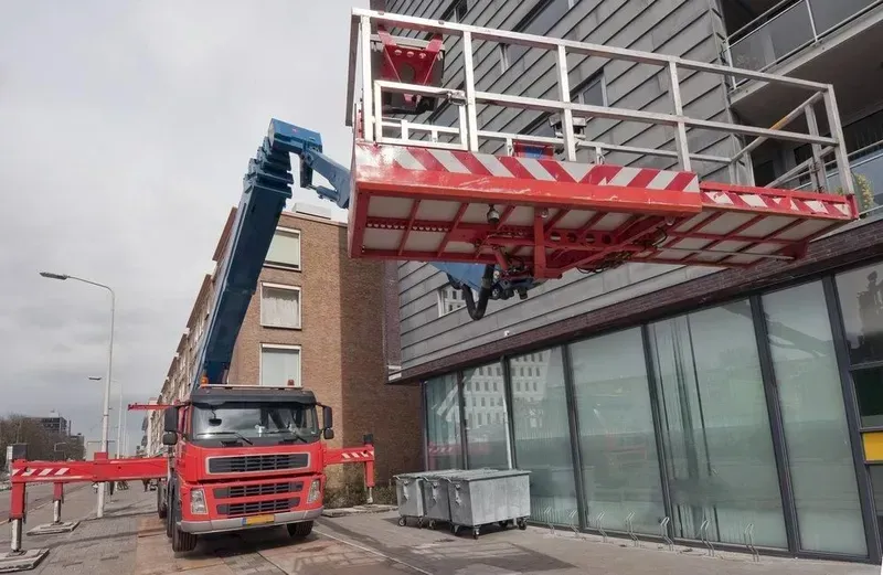 A Truck Is Parked in Front of A Building with A Crane Attached to It — North Coast Cranes In Grafton, NSW